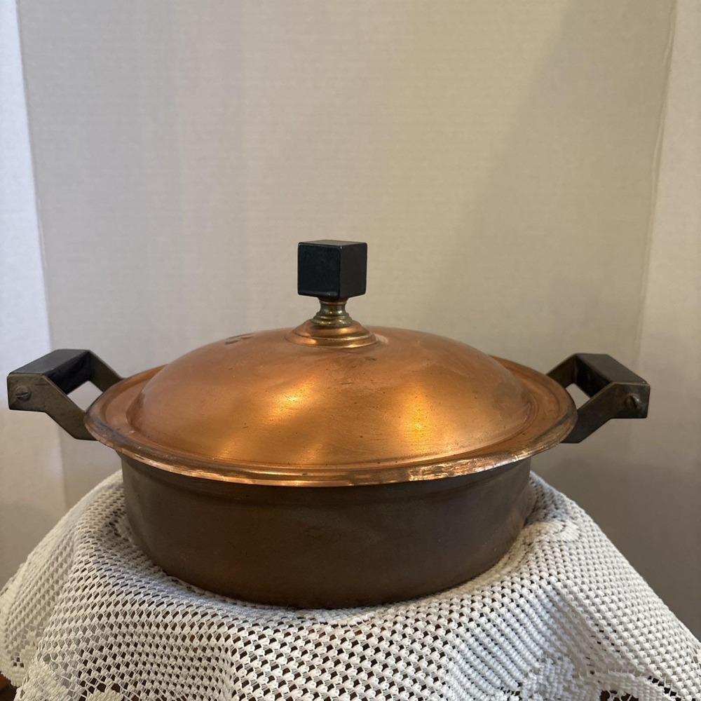Vintage Bazar Francais copper chafing dish with black handles and knob.